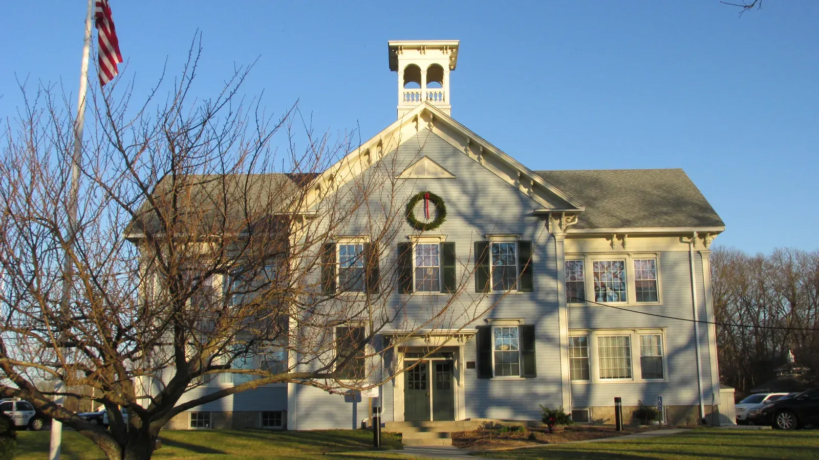 The Parting of the Ways Building, a white Greek Revival civic building with a cupola and green shutters, Acushnet, Massachusetts