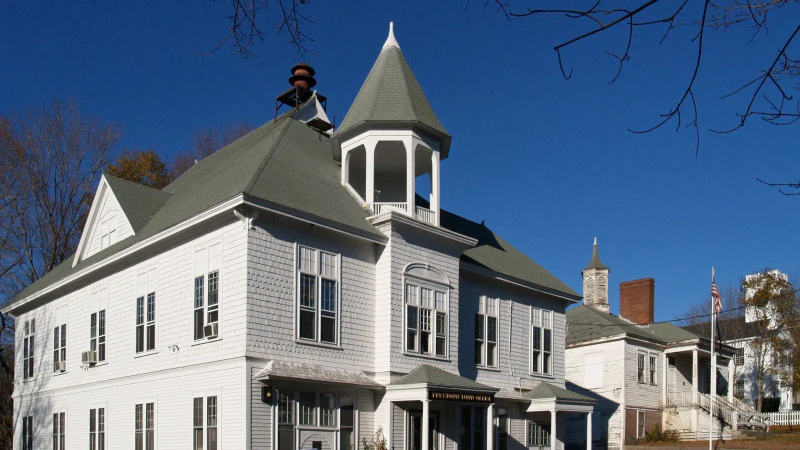 White clapboard civic buildings with a turreted cupola in the Assonet village historic district, Freetown, Massachusetts