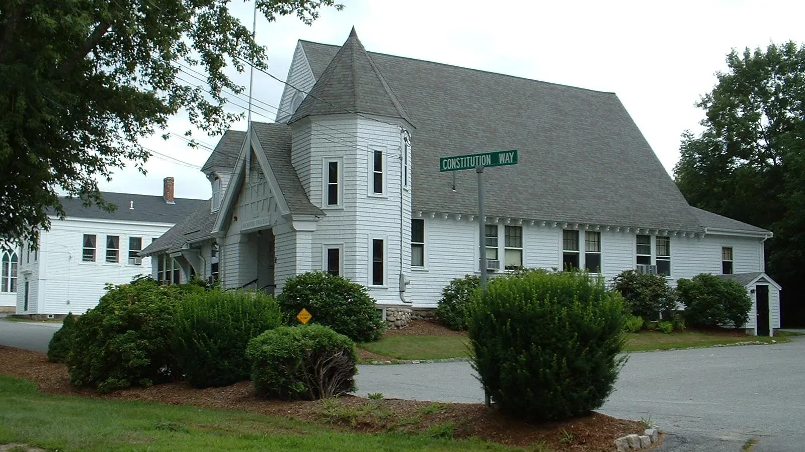 Rochester Town Hall, a white shingle-style building with a round corner turret and gabled roof, Rochester, Massachusetts